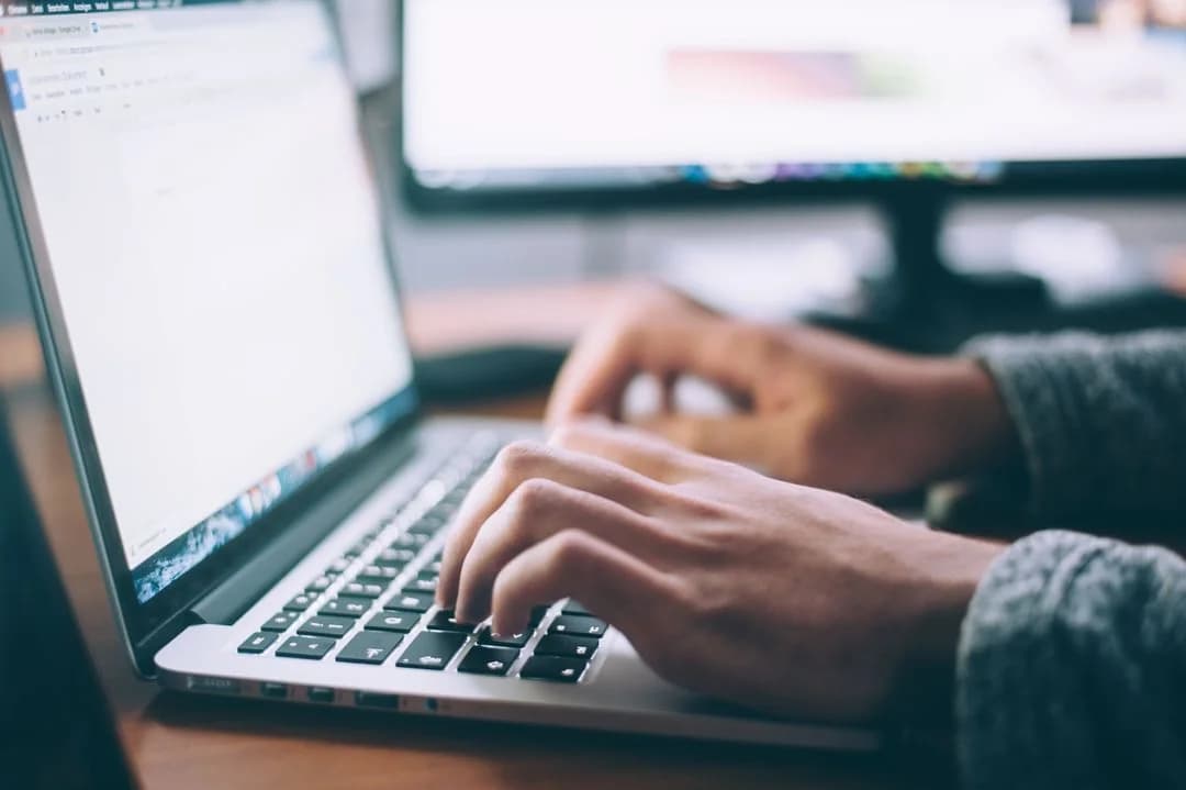 A person typing on a laptop 